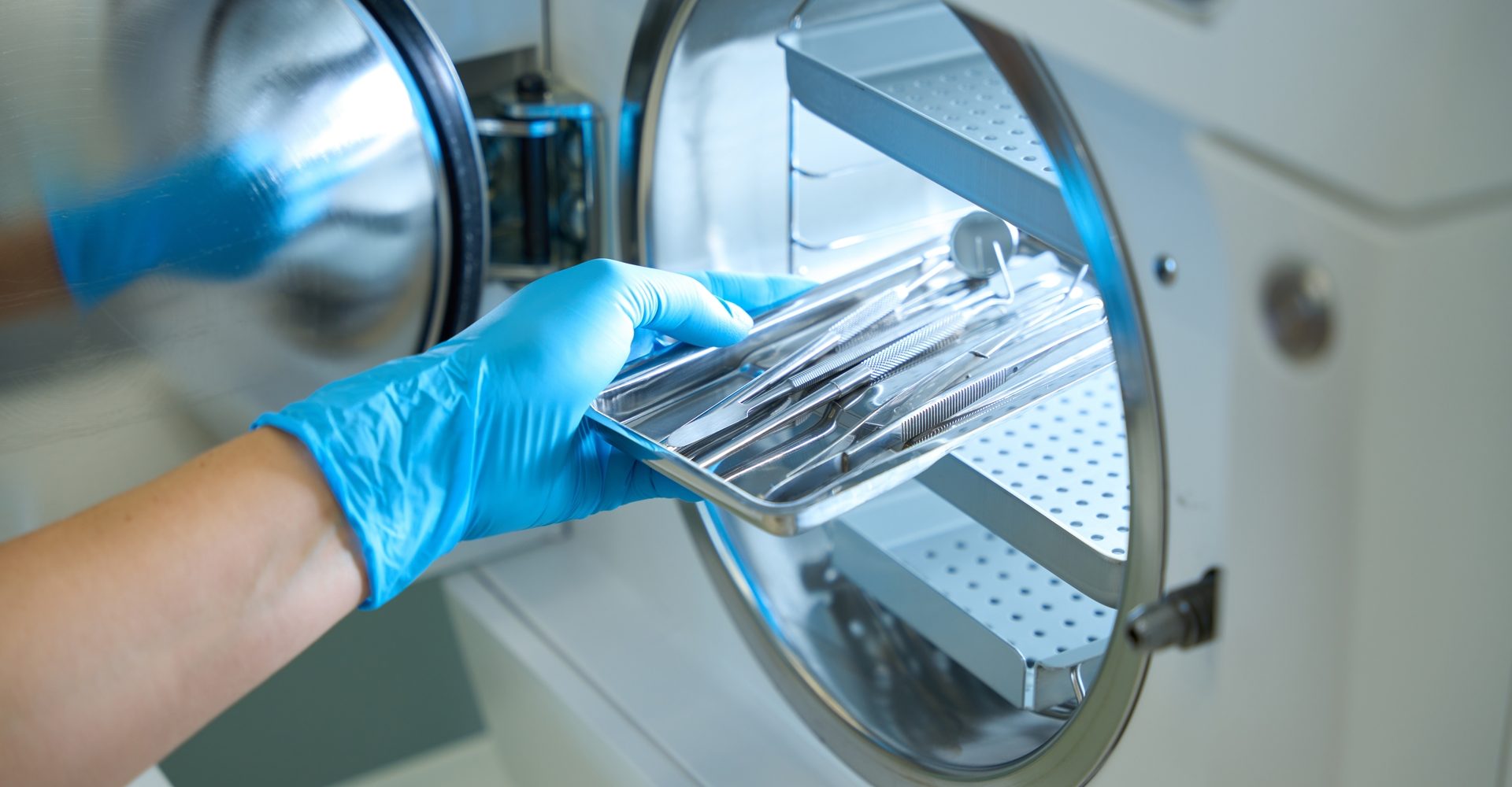 Woman,Hand,In,Gloves,Puts,Dental,Instrument,Into,Sterilization,Apparatus