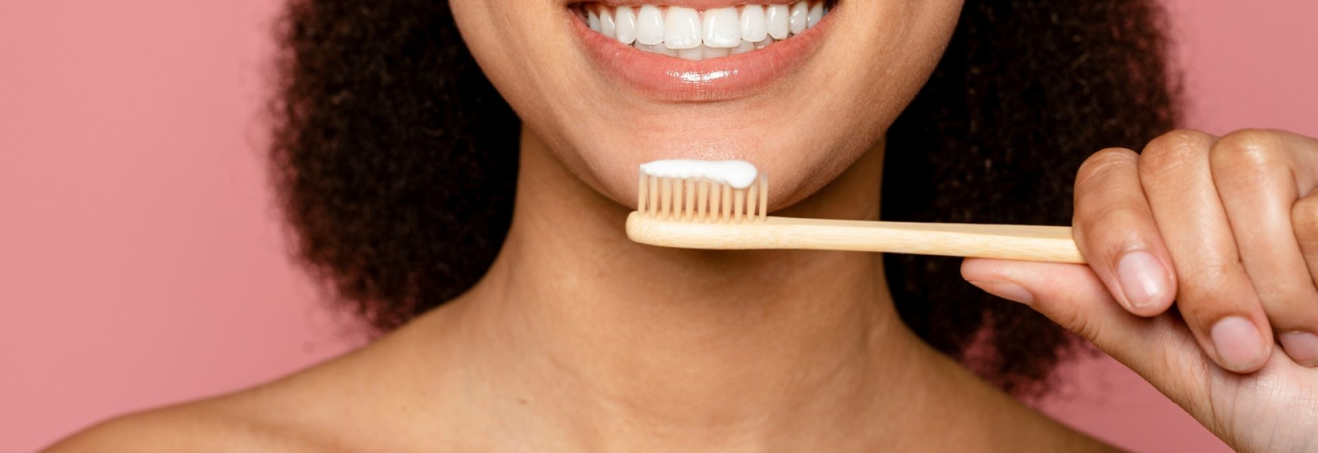 Wooden,Eco,Toothbrush,,Dental,Care,And,Sustainability,Against,Pink,Background.